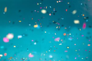 Multicoloured glitter flowing on a blue background