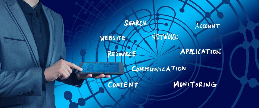 A business professional in a gray suit interacts with a tablet against a blue digital background featuring abstract network and circuit patterns. Around the person, handwritten-style words—“Search,” “Website,” “Resource,” “Content,” “Network,” “Communication,” “Account,” “Application,” and “Monitoring”—are scattered, symbolizing interconnected aspects of technology and online systems. The image conveys themes of digital communication, data management, and network infrastructure.